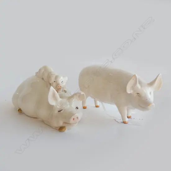 TWO BESWICK PIGS  (LARGEST L 165MM) 1 EAR IS  AF