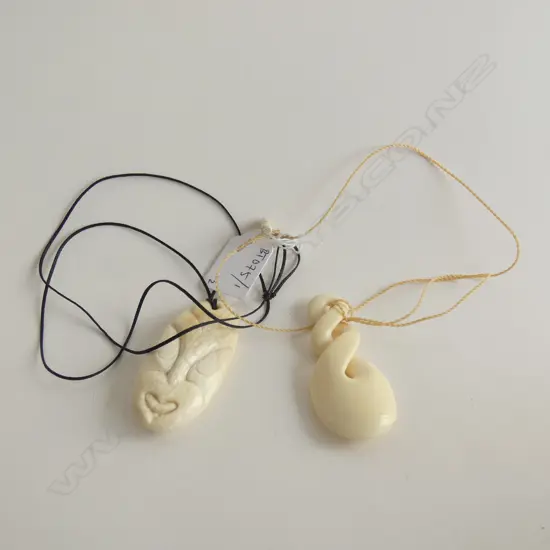 2 CONTEMPORARY BONE PENDANTS ON PLAITED CORDS
