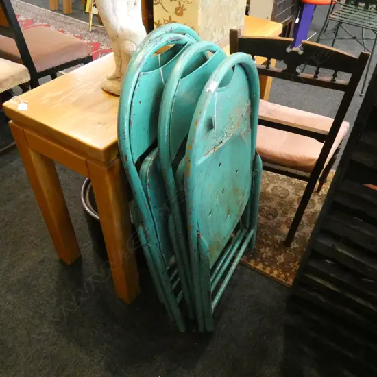 FOUR GREEN METAL FOLDING CHAIRS