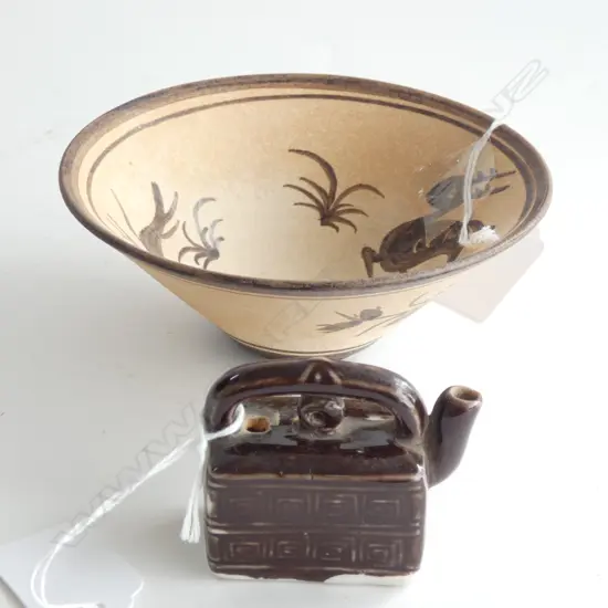 the bowl biscuit fired and decorated in brown with birds and floral design