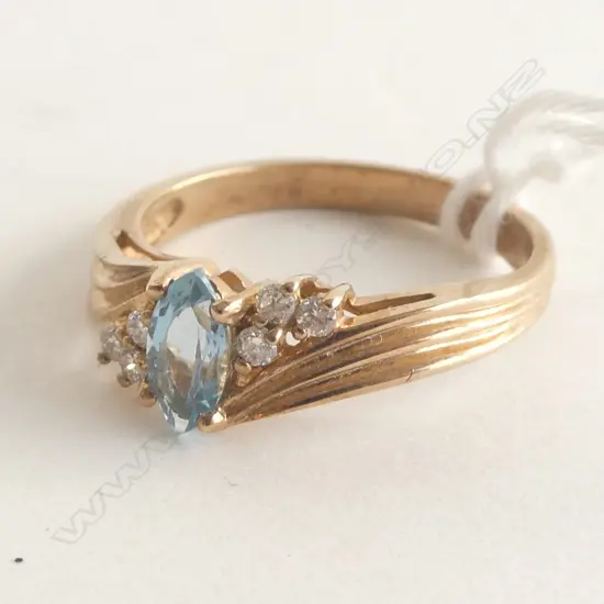 9CT PALE OVAL BLUE TOPAZ & DIAMOND RING