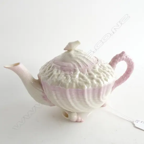 A BELLEEK TEAPOT, BLACK MARK, PINK AND WHITE SHELL