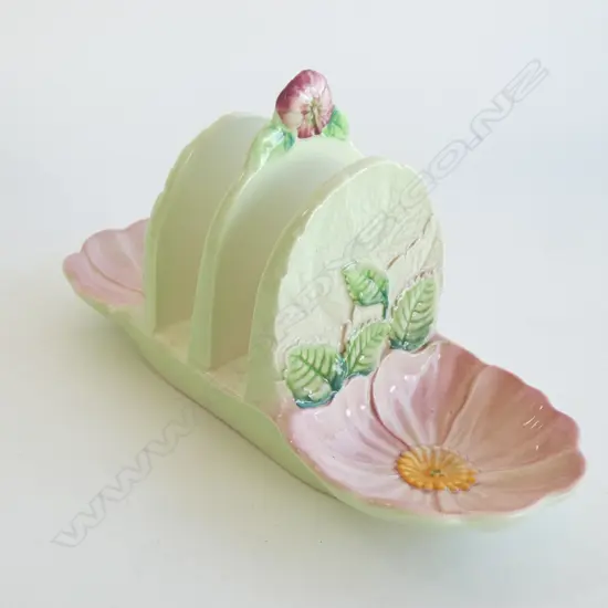A CARLTON WARE EMBOSSED TOAST RACK, PINK FLOWERS JAM HOLDERS AT EACH END