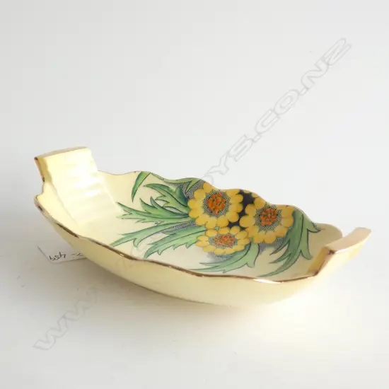 A CARLTON WARE LUSTRE DISH. YELLOW WITH YELLOW DAISY-LIKE FLOWERS AND SPIKY LEAVES. L.170mm