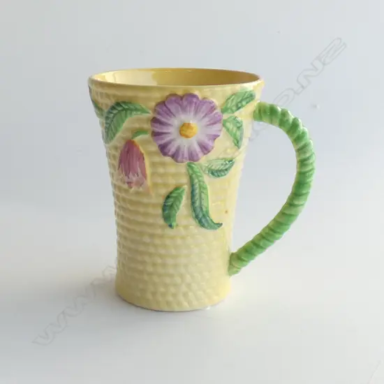 A CARLTONWARE EMBOSSED CHOCOLATE MUG, YELLOW