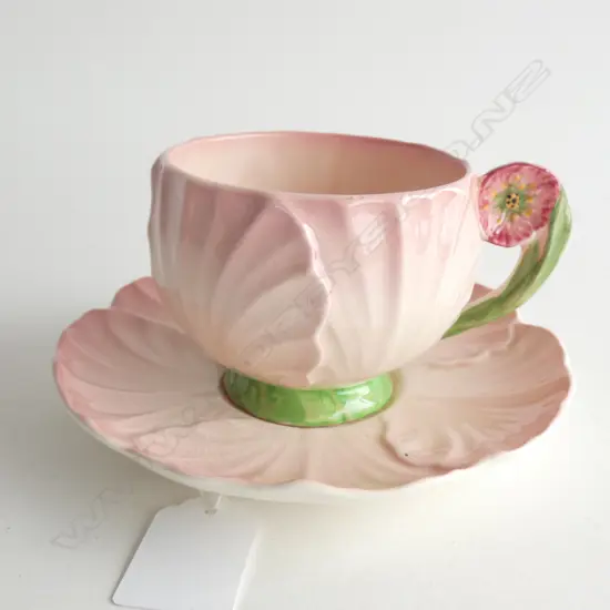 A CARLTON WARE EMBOSSED PINK BUTTERCUP CUP AND SAUCER