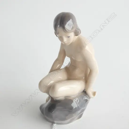 A ROYAL COPENHAGEN GIRL SITTING NAKED ON ROCK, SIGNED (1894-1922) w PAPER LABEL ON BASE…
