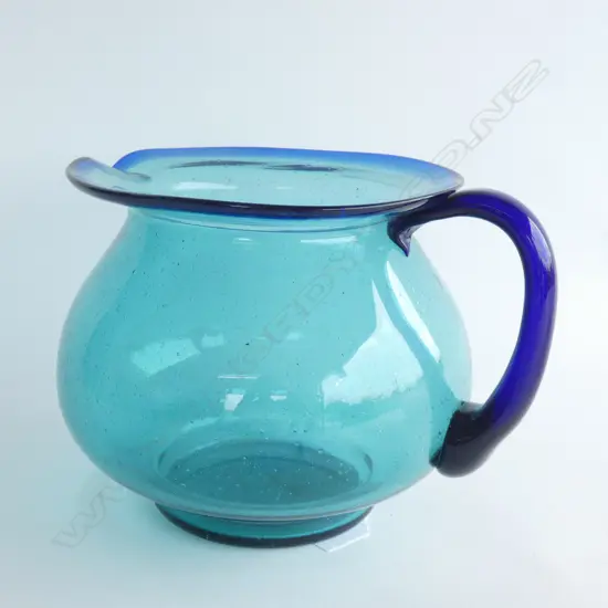AN ART GLASS CLEAR TURQUOISE JUG, H.190mm