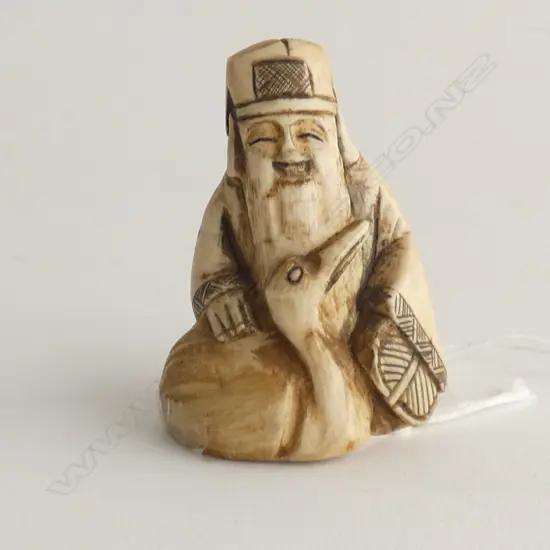 JAPANESE CARVED IVORY NETSUKE; GOD OF FORTUNE H.50mm