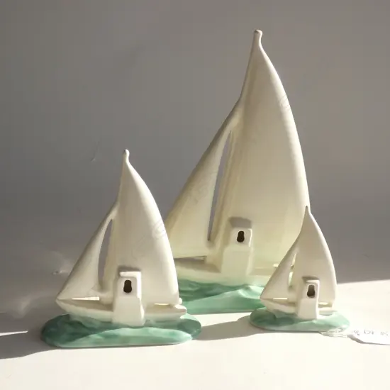 A graduated set of three Poole yachts