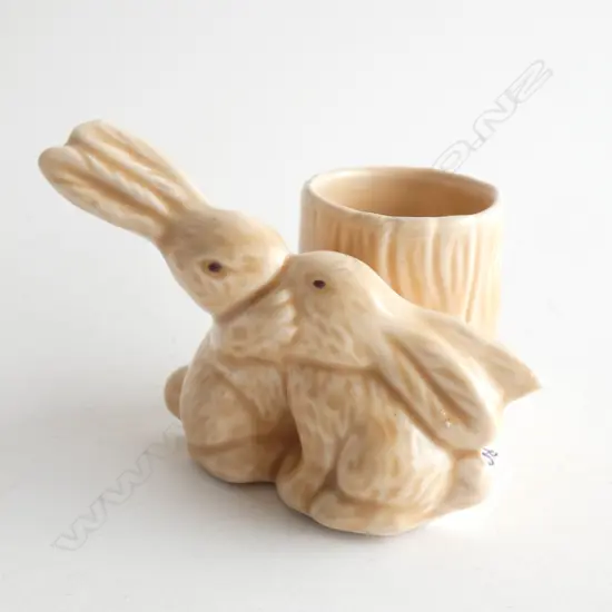 A Sylvac kissing rabbits match holder and striker