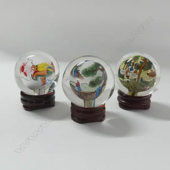 3 ORIENTAL GLASS INTERNALLY PAINTED BALLS ON WOODEN STANDS H 50MM