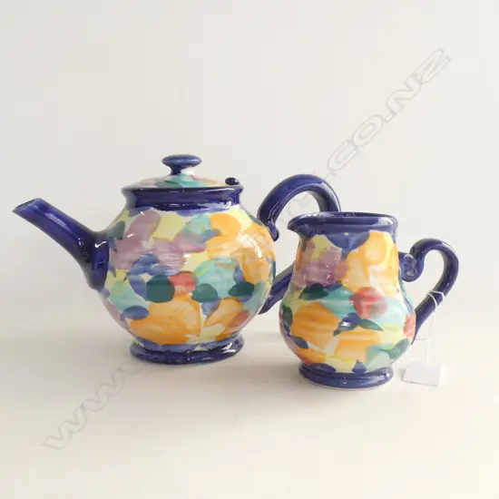 MULTI COLOURED TONY SLY POTTERY; TEAPOT (4 CUP) & MILK JUG
