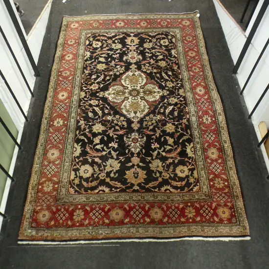 IRANIAN HAND KNOTTED RUG, BLACK GROUND CNETRAL FLORAL MEDALLION & ISLIMI TENDRILS. 2180 x 1440mm