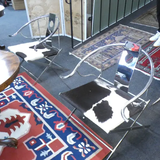 PAIR OF STYLISH CHROME AND COWHIDE YOKE CHAIRS