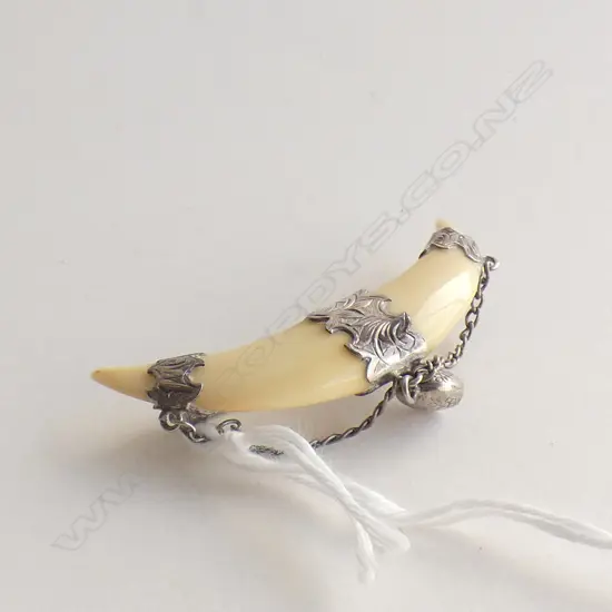 ANTIQUE SILVER MOUNTED TUSK BROOCH