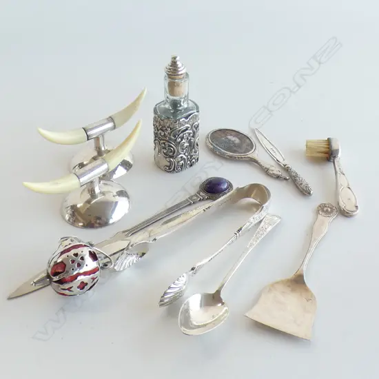 ASST. STG SILVER ITEMS; TONGS, BOTTLE, SWORD LETTER OPENER + EP KNIFE RESTS ETC