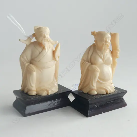 TWO CARVED IVORY FIGURES ON STANDS