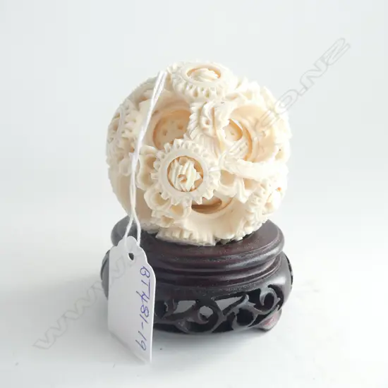 UNUSUAL CARVED IVORY PUZZLE BALL WITH WITH 12 MINIATURE PUZZLE BALLS TO TOP LAYER ON CARVED WOOD STAND