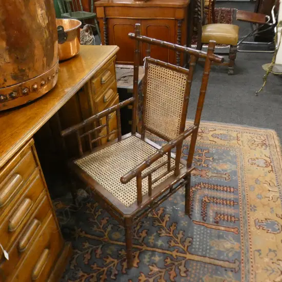 FAUX BAMBOO (WALNUT?) & WOVEN CANE CHAIR