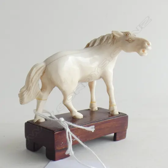 IVORY CARVED HORSE ON WOODEN PLINTH L 70MM