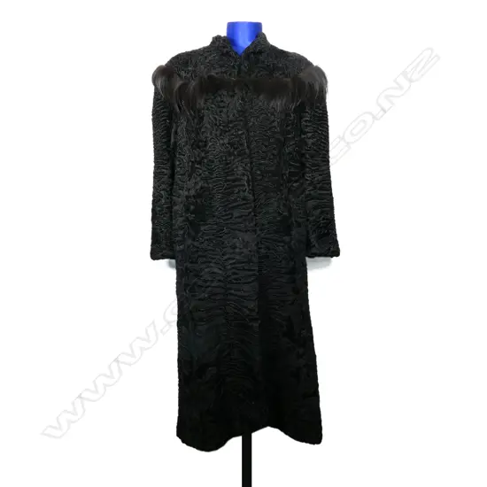 A black Astrakhan full-length coat,