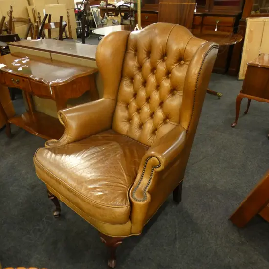 DARK TAN TASMAN LEATHER 'MONTREUX' BUTTON WING BACK ARMCHAIR; BRASS STUD DETAIL