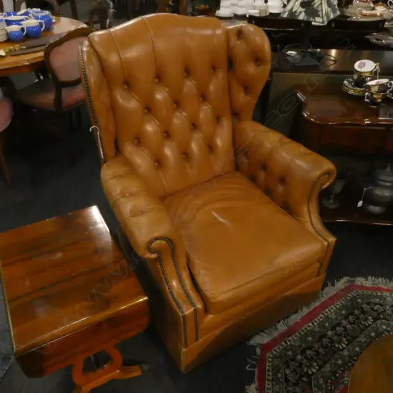 TAN LEATHER BUTTON WING BACK ARMCHAIR; BRASS STUD DETAIL