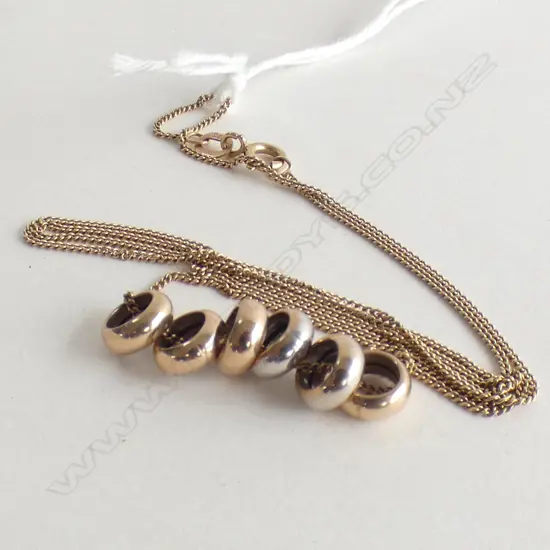 9CT ROSE GOLD 6 RING NECKLACE. FINE CHAIN 2.77gms