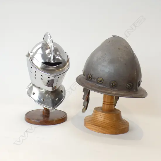 2 MID SIZE ARMOUR HELMETS ON WOODEN STANDS H 115MM
