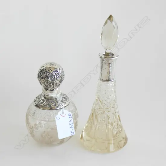 2 VINTAGE GLASS SCENT BOTTLES; 1 WITH STG COLLAR & LID LONDON C1916 (H110MM) & 1 STG COLLAR C 1900 (H170MM)