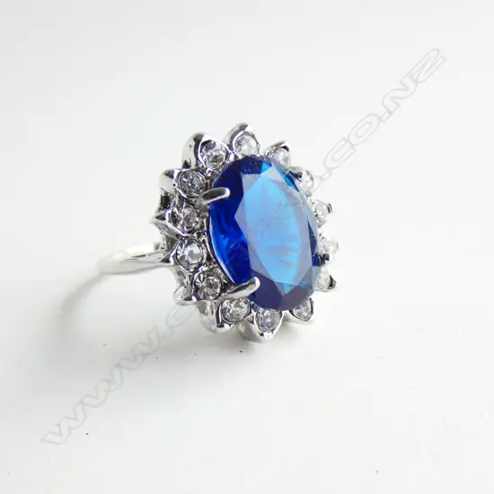 SILVER TONED RING WITH LARGE FAUX SAPPHIRE AND DIAMONDS 