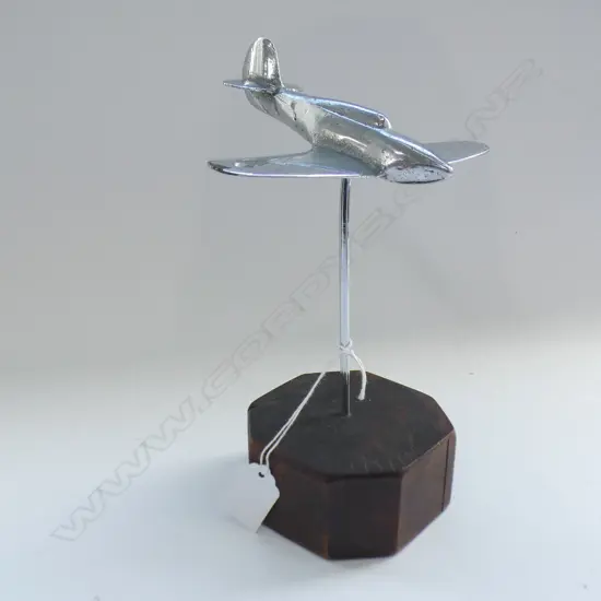 CHROME AEROPLANE SPITFIRE TYPE ON OCTAGONAL SHAPED WOOODEN BASE. H.230mm