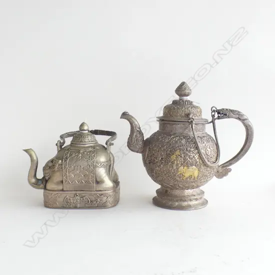 2 SILVER / WHITE METAL TEAPOTS, ONE AS AN ELEPHANT (QIANLONG MARK), THE OTHER PROBABLY SRI LANKAN. TALLEST 190mm