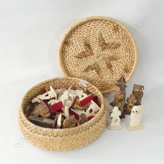 WOVEN BASKET OF CARVED CHESS PIECES 