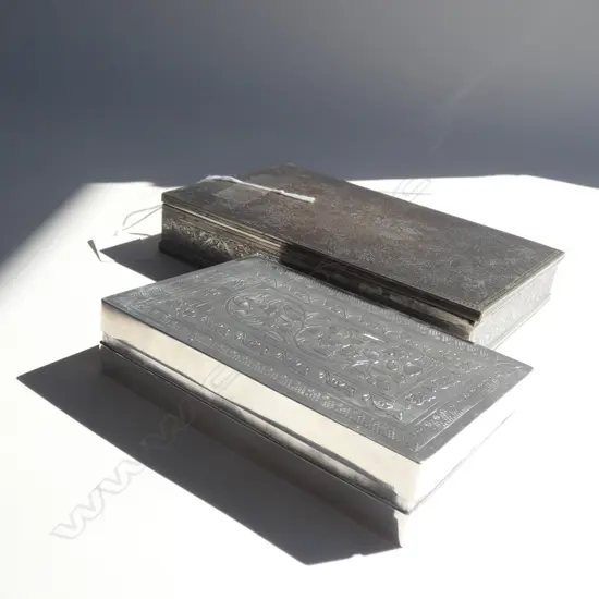 2 CIGARETTE BOXES, ONE SILVER PLATE, THE OTHER PROBABLY EGYPTIAN SILVER. W.170mm