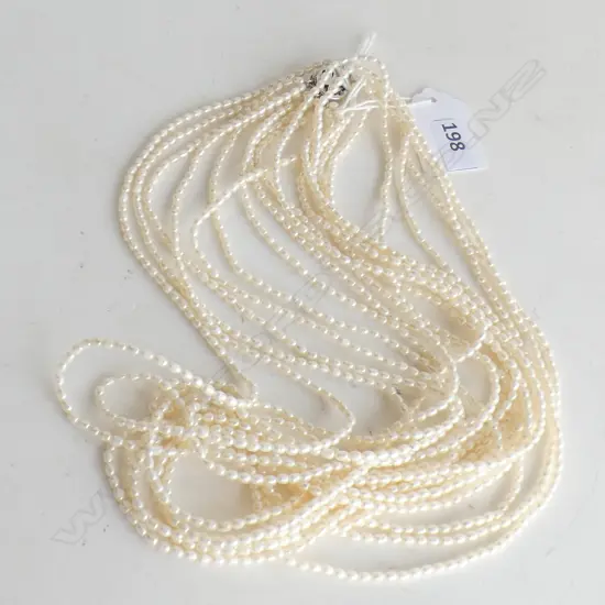 9 STRING SEED PEARL NECKLACE WITH ORNAMENTAL CLASP