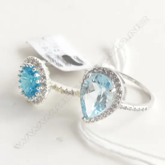 2x SILVER & BLUE STONE (TOPAZ?) RINGS