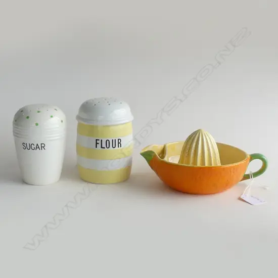 DECORATIVE KITCHEN ITEMS; CROWN DEVON ORANGE SQUEEZER, YELLOW CORNISHWARE FLOUR SHAKER & GREEN POLKA DOT SUGAR SHAKER