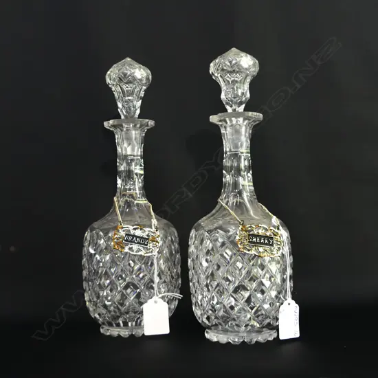 2 VINTAGE HEAVY CUT GLASS DECANTERS W SWING TAGS; BRANDY & SHERRY (H 290MM)  A/F
