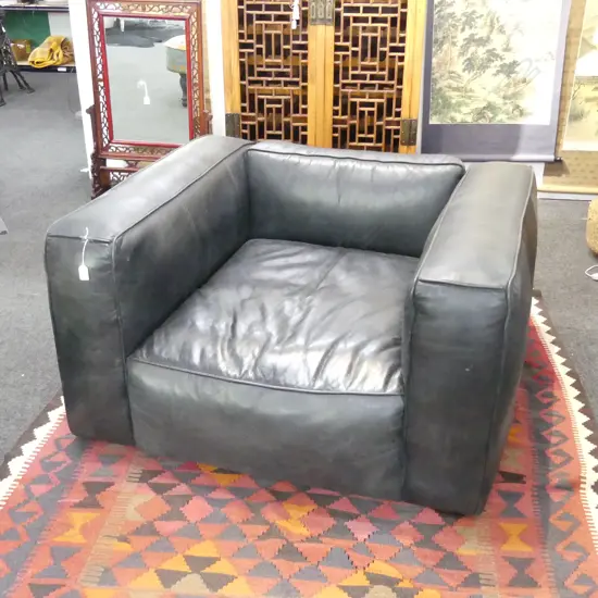 LARGE MODERNIST BLACK LEATHER ARMCHAIR