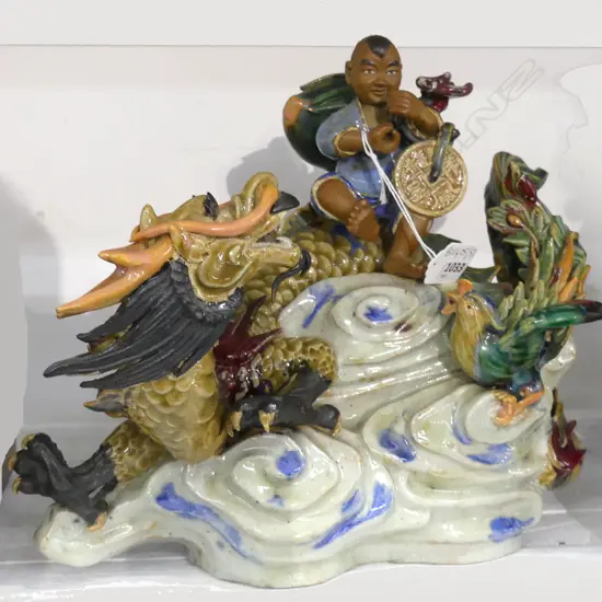 CHINESE 'MUDMAN' CERAMIC; MAN ON DRAGON W.300mm minor loss