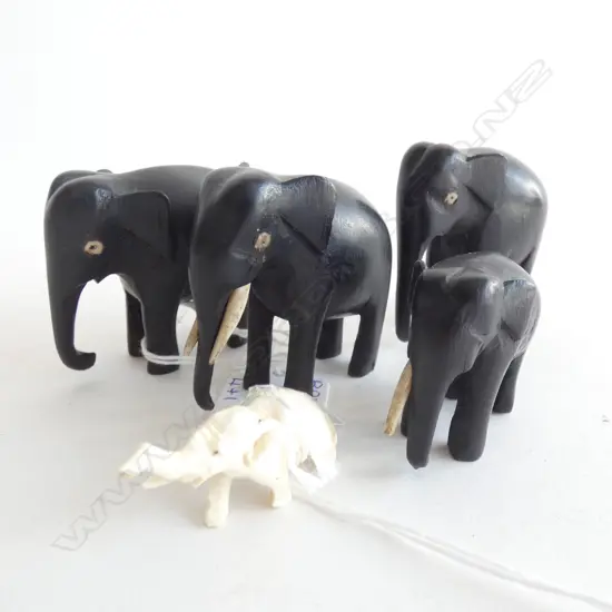 4 EBONY ELEPHANTS (TUSKS MISSING ON 3 ) L 52MM + SM IVORY ELEPHANT L 43MM)