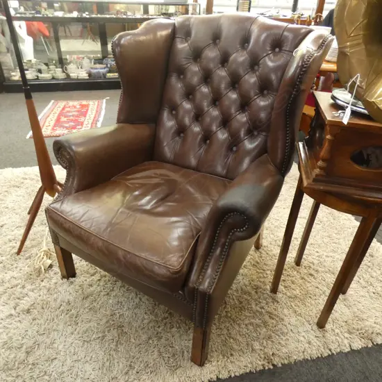 BROWN LEATHER WING BACK CHAIR
