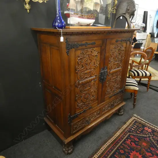 CARVED OAK CONTINENTAL CUPBOARD...