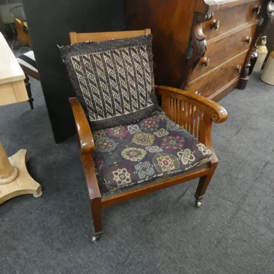 OAK MORRIS STYLE CHAIR ON CASTORS WITH KELIM CUSHION, 1900s