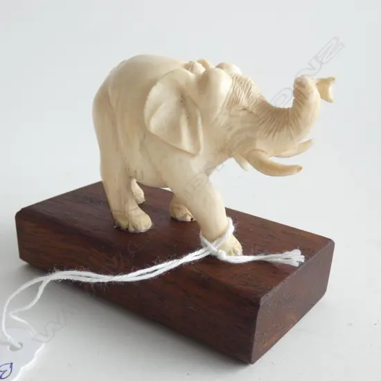 FINELY CARVED IVORY ELEPHANT ON WOOD STAND