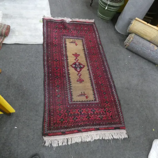 A HANDKNOTTED BALUCHI RUG 1630 X 820 MM