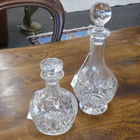 TWO CUT GLASS DECANTERS; H. 330 & 200MM  (1 STOPPER HAS SOME CHIPPING AROUND THE END)