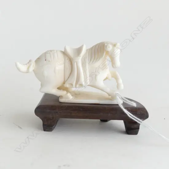 CARVED IVORY SITTING HORSE ON WOODEN STAND L 80MM